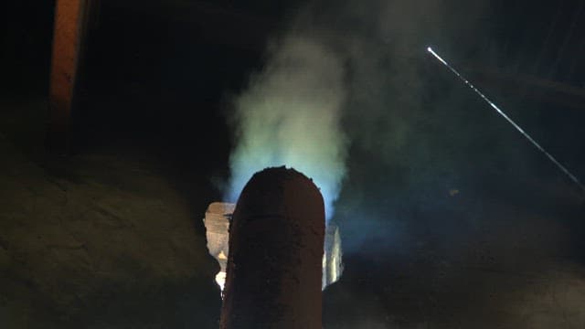 Smoke rising from a chimney indoors