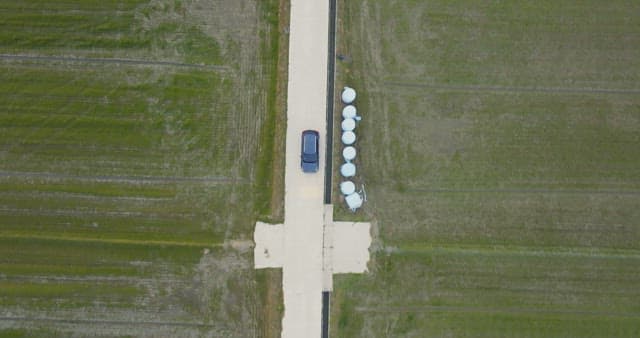 Car driving through rural farmland