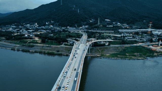Bridge over a river with cars moving