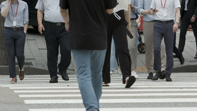 Busy Pedestrians Crossing an Urban Street
