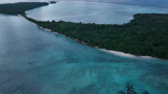 Island at dawn with clouds and ocean
