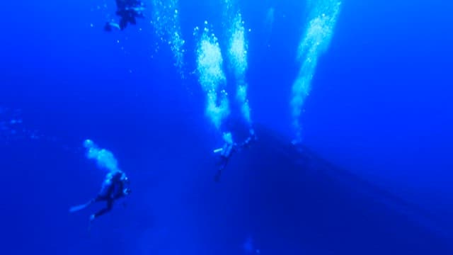 Scuba divers entering the deep sea