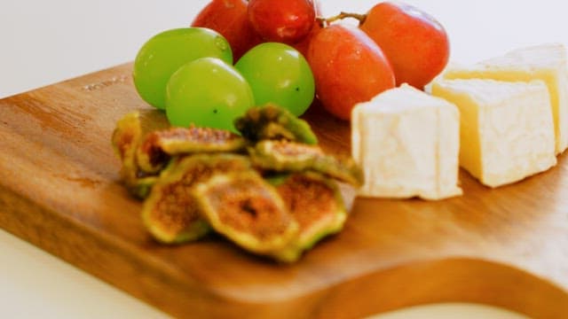 Assorted Fresh Fruits and Cheese on Wooden Board