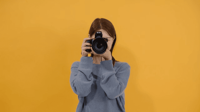 Woman taking pictures with a DSLR camera