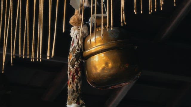Golden bell hanging at a traditional shrine