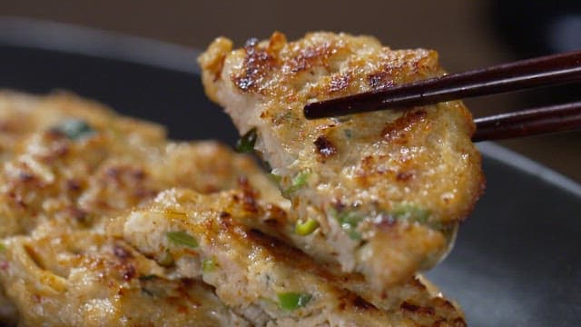 Chopsticks picking up golden-brown fried donggeurangtang