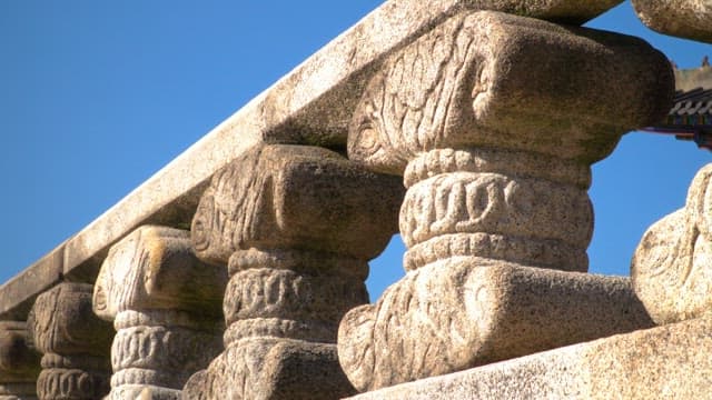 Ornate stone railing in Korean temple under blue sky