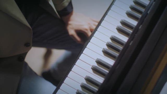 Close-up of hands playing the piano