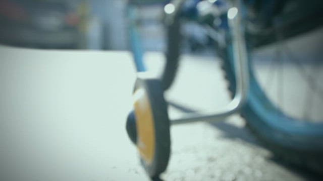 Child Riding Bicycle in Alley