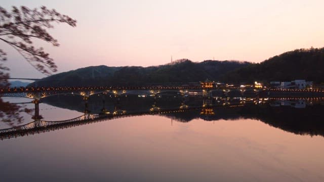Scenic bridge over a calm river at sunset
