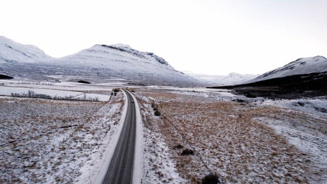 Snowy mountains and road with cars