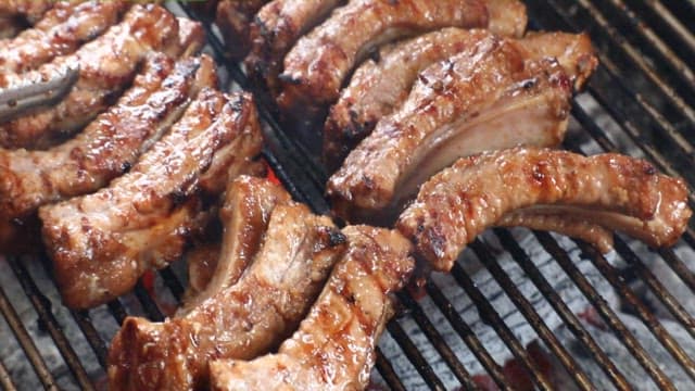 Juicy and tender ribs grilling over charcoal outdoors
