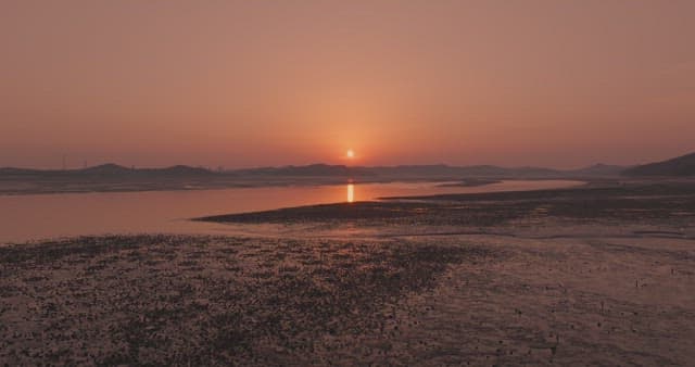 Sunset over a serene coastal landscape