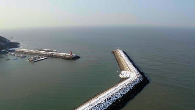 Snow-covered coastal view from a mountain top