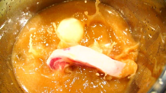 Pork belly simmering in a pot with broth
