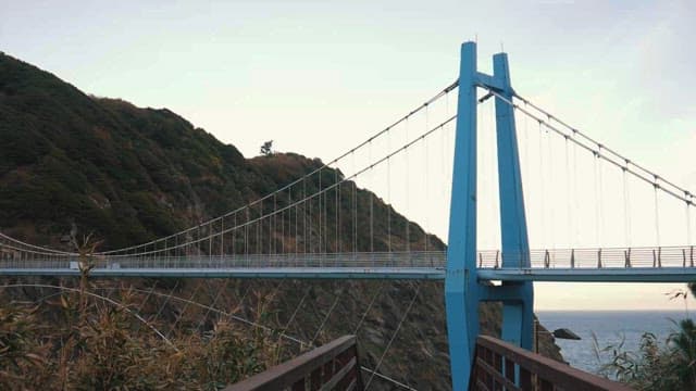 Serene Coastal Suspension Bridge at Dusk