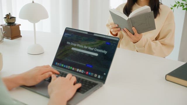 Two people enjoying leisure time at the white table in the living room