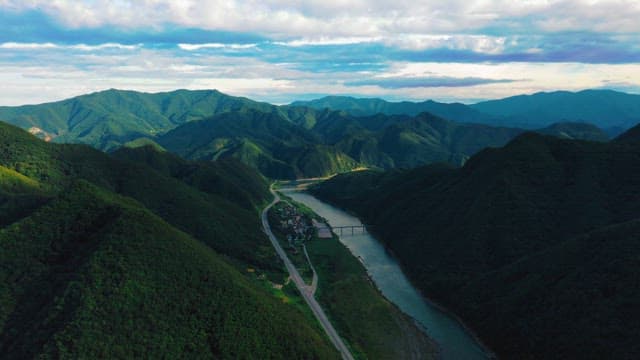 Breathtaking Aerial View of a River Winding Through Mountains