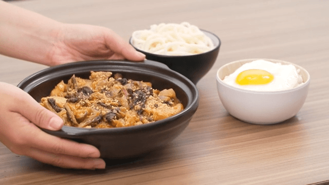 Table topped with warm dried radish greens and pork belly stew and fried egg