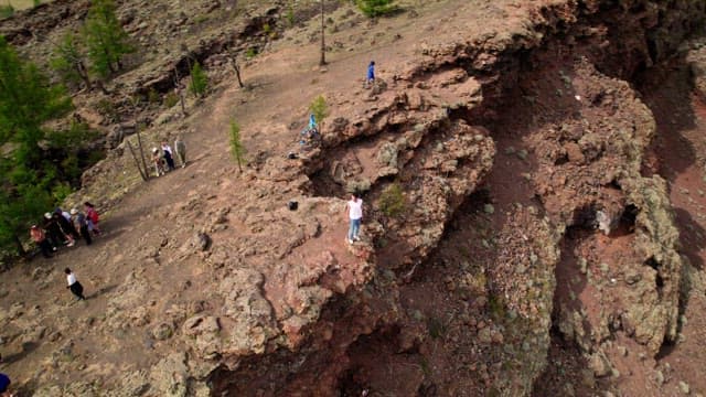 People Touring Steep Dirt and Rock Pits