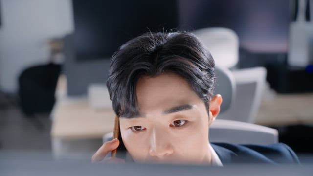 Man talking on the phone at his desk