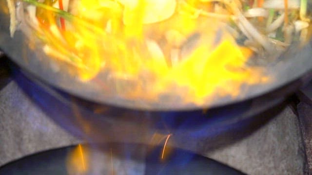 Stir-frying vegetables with flames