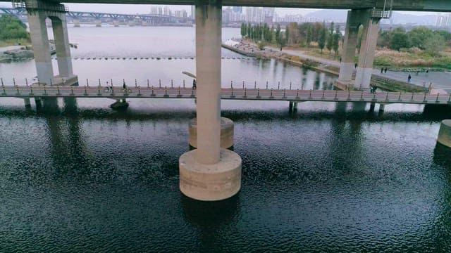 Overcast Day at the Riverside with Concrete Bridge