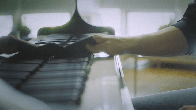 Hands wiping piano keys