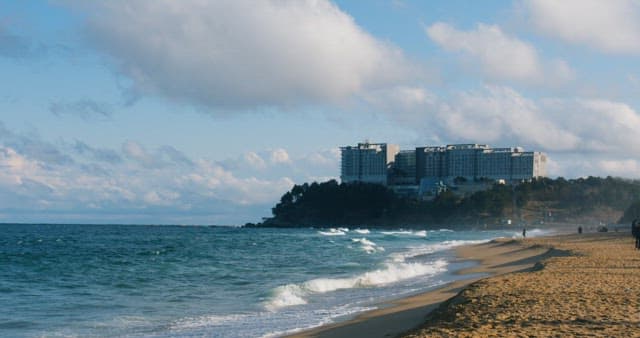 Serene Beach with Coastal Hotel in Sunshine