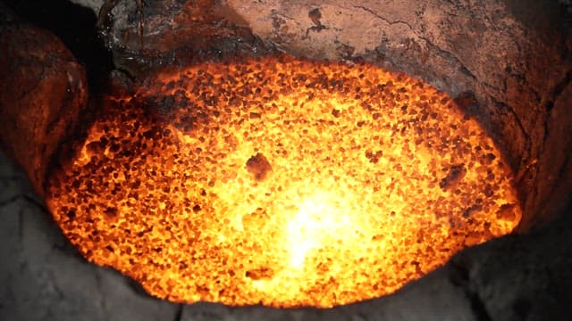 Molten metal glowing in a furnace