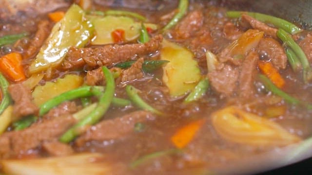 Beef and vegetable simmering in a pan