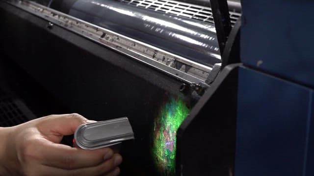 UV lamp shines on a large industrial fluorescent ink printer
