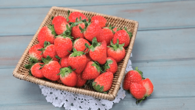 Basket of fresh strawberries on a table