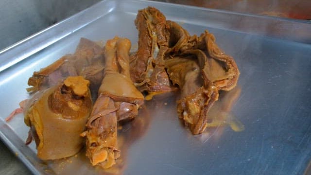 Steaming pig's feets on a metal tray