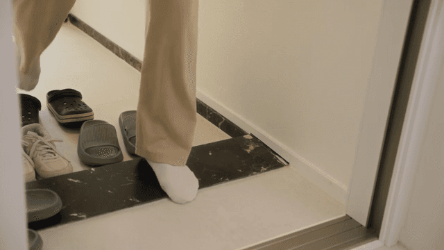 Changing slippers at the apartment entrance