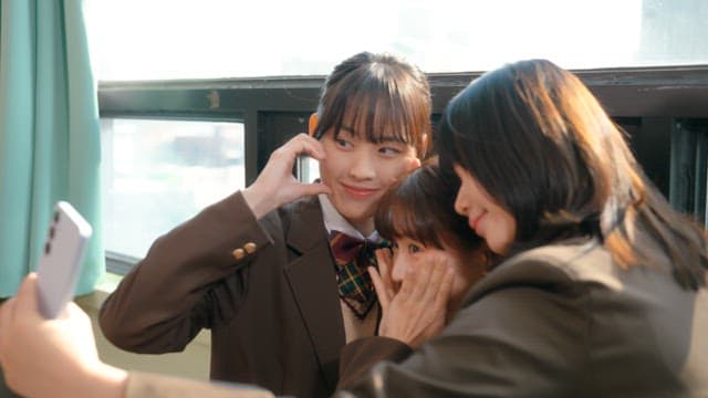 Students taking selfies in a classroom