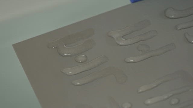 Letters written with water droplets on hydrophobic surface treated paper
