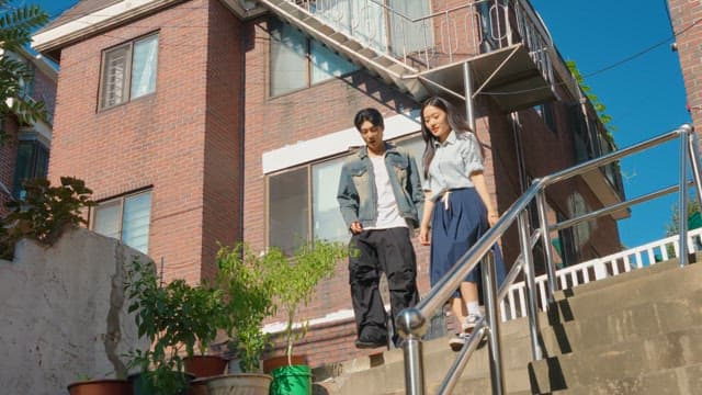 Couple walking down sunny stairs