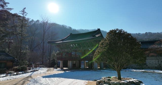 Serene Temple in a Snowy Landscape under Sunshine