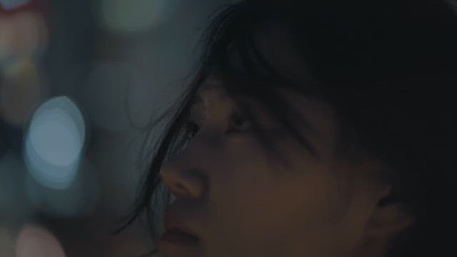 Contemplative Woman against a backdrop of city lights