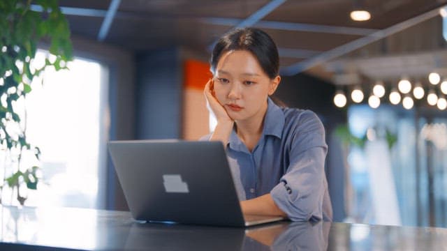 Woman working on a laptop in an office