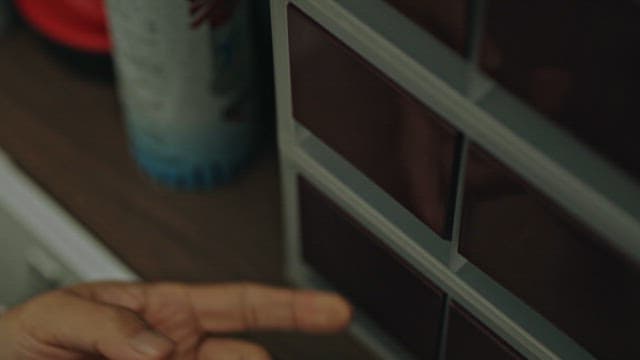 Close-up of a Person's Hand Retrieving Keys from Drawer