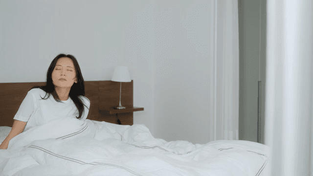 Woman Waking Up in Bed