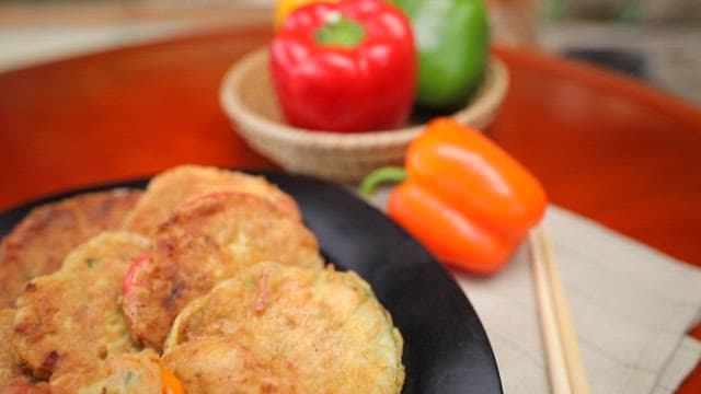 Plate of meatballs plated with various colored bell peppers