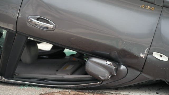 Car overturned on the road after an accident and person