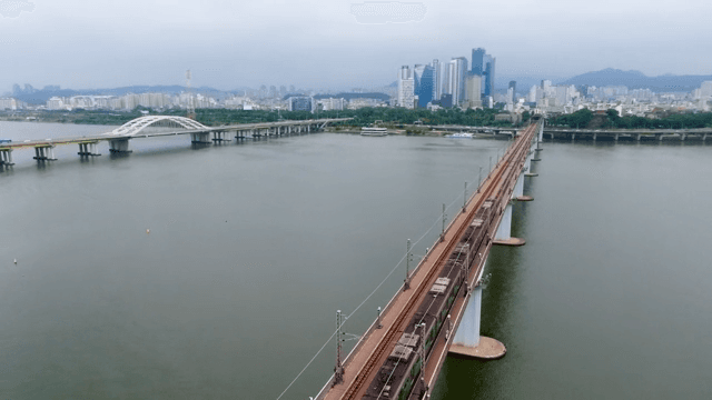 Urban Subway Crossing the River Bridge
