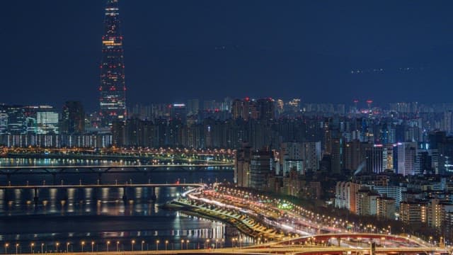 Illuminated Cityscape with Rivers and Bridges at Night