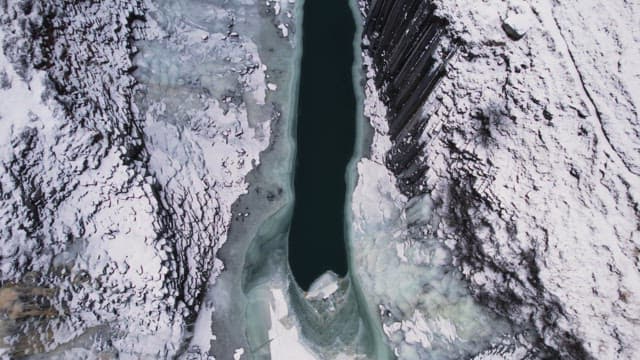 Snow-covered canyon with a frozen river