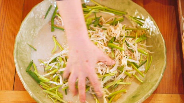 Close-up of hand mixing fresh vegetables