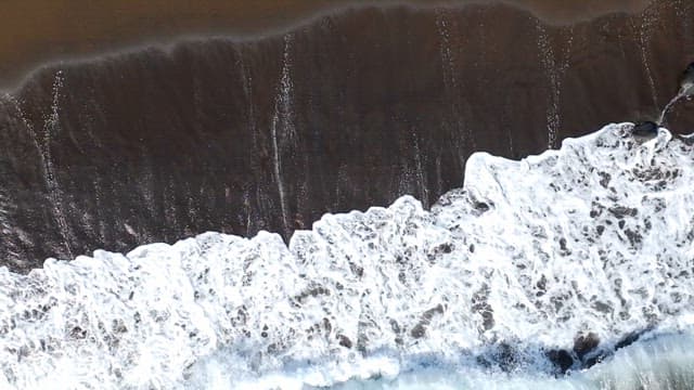 Waves crashing on a sandy beach